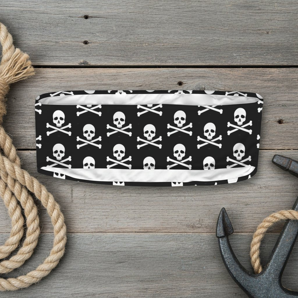 Black headband with white skull and crossbones pattern on a white background