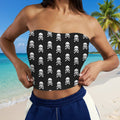 Woman wearing a strapless Skull Tube Top with skull and crossbones pattern a Caribbean Island Beach