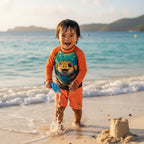 little surfer dude wearing a A long-sleeve raglan rash guard shirt with bright orange sleeves and a colorful puffer-fish graphic on St. John Island Beach