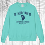 A mint green crewneck sweatshirt with a dark blue graphic print on the front reading 'ST. SOMEWHERE Caribbean Islands Where It's Warm Since 149' with an eagle head illustration, displayed flat against a white wood plank background.