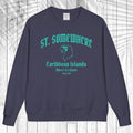 A navy blue crewneck sweatshirt with a teal graphic print reading 'ST. SOMEWHERE Caribbean Islands Where It's Warm Since 1994' and a bird silhouette, displayed flat against a white wood plank background.