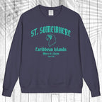 A navy blue crewneck sweatshirt with a teal graphic print reading 'ST. SOMEWHERE Caribbean Islands Where It's Warm Since 1994' and a bird silhouette, displayed flat against a white wood plank background.