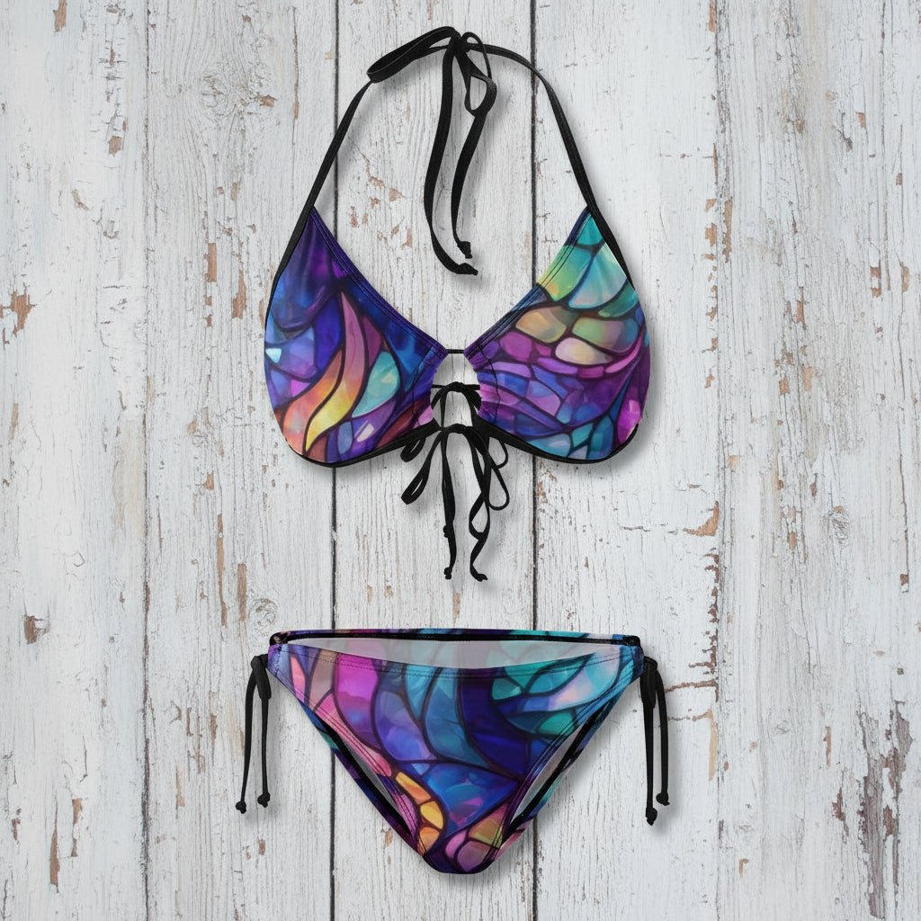 Multicolored bikini set with black straps on a white background