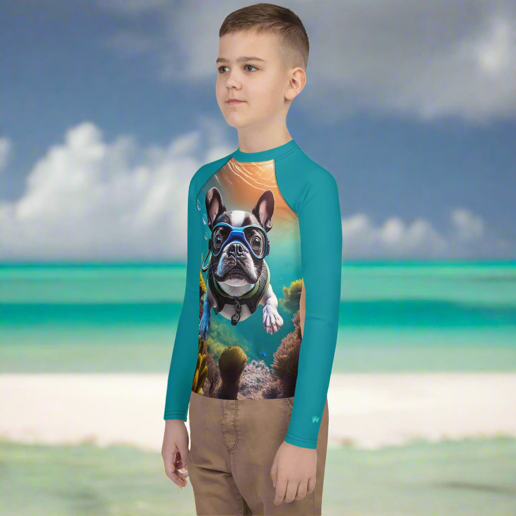 Boy wearing Sun Rashie with Snorkeling Frenchie Pup on a beach in St. Thomas