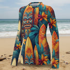 Colorful long-sleeve shirt with tiki mask and surfboard design on a beach background
