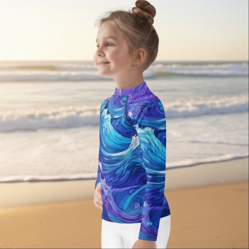 Child wearing a colorful rash guard with a wave design on a faded beach background