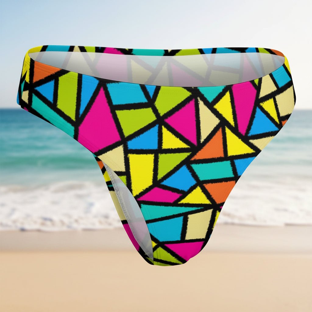 Colorful geometric patterned swim brief on a faded beach background