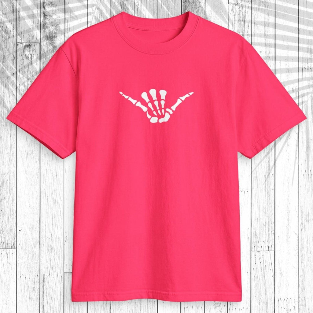 A bright pink short-sleeve t-shirt with a white skeletal hand graphic on the chest, displayed flat against a white wood plank background.
