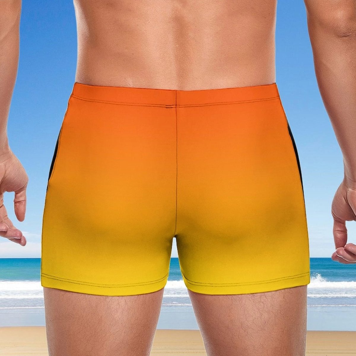 Guy wearing a yellow to orange gradient swim short with a beach background