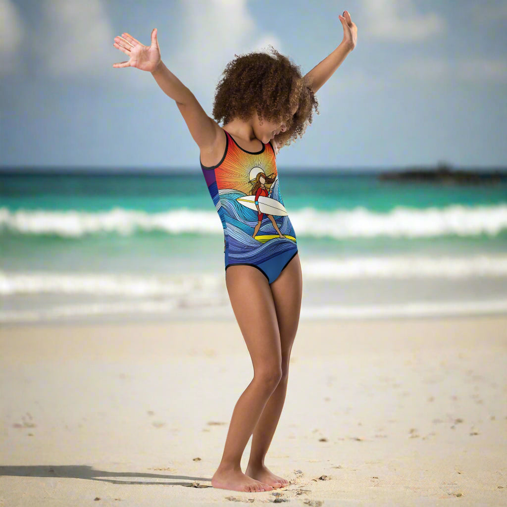 little girl dancing on the beach in her new surfer girl one piece by Bongo Beachwear