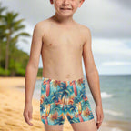 Child wearing colorful tropical-themed swim shorts, hanging loose on the Hawaiian North Shore