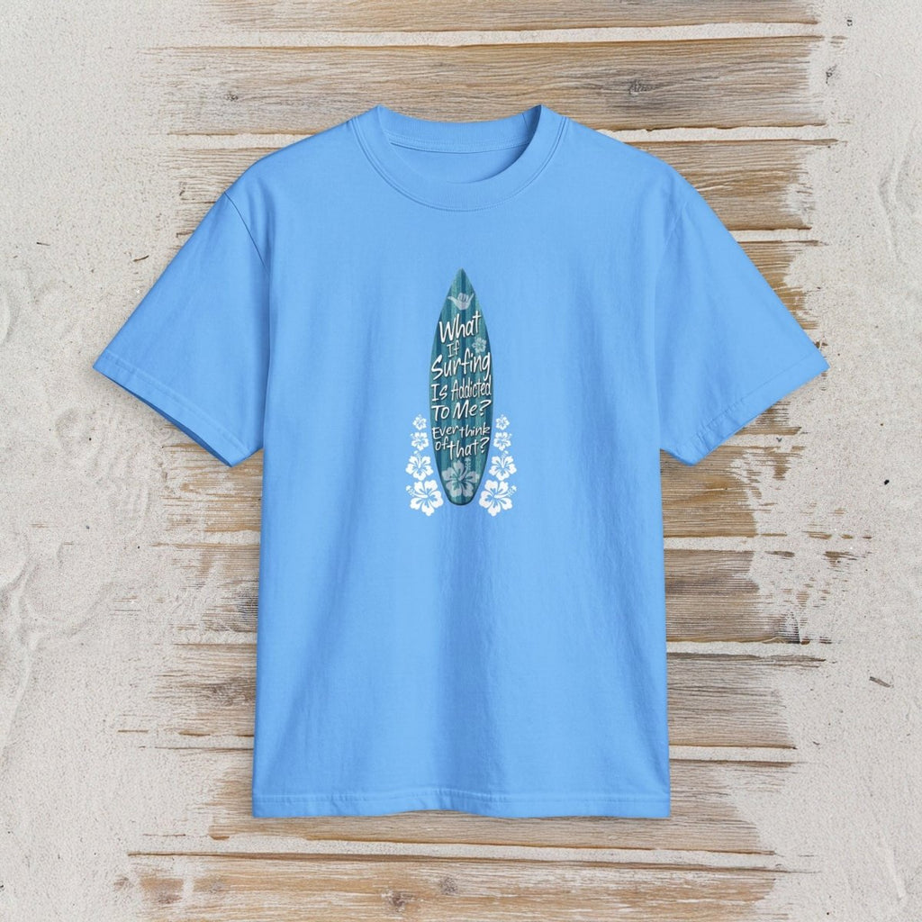 A blue short-sleeve crewneck t-shirt featuring a vertical blue surfboard graphic with the text 'My World Is Surfing To Me' on a rustic, whitewashed wooden background.