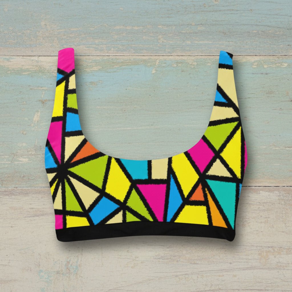 Colorful geometric-patterned crop top on a rustic wood background