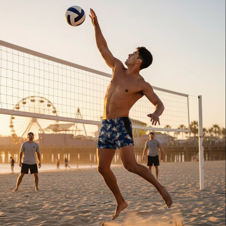 Man playing beach volleyball on a sandy court with a sunset background