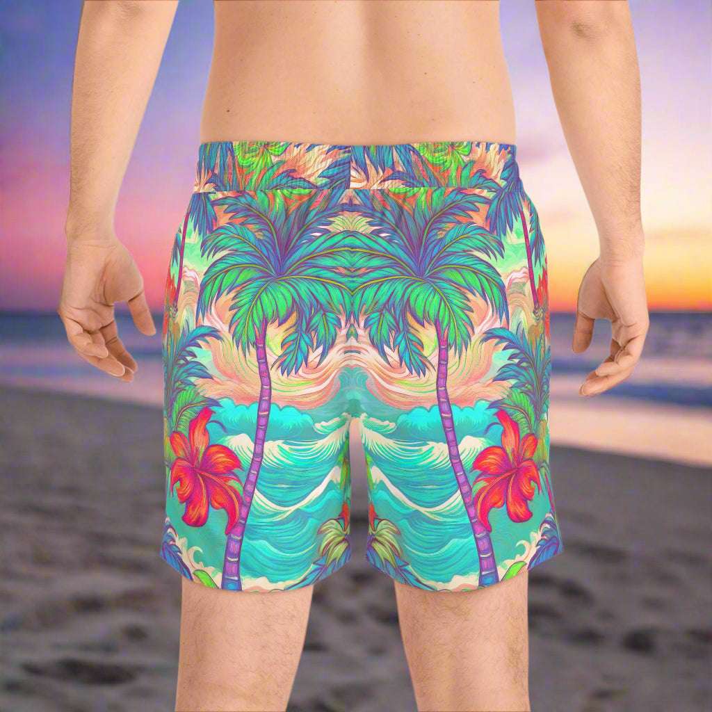 Surfer wearing Bongo Beachwear Hawaiian style swim shorts standing on the beach watching the tide come in.