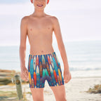 tween kid wearing colorful surfboard-patterned shorts on a beach in Waikiki