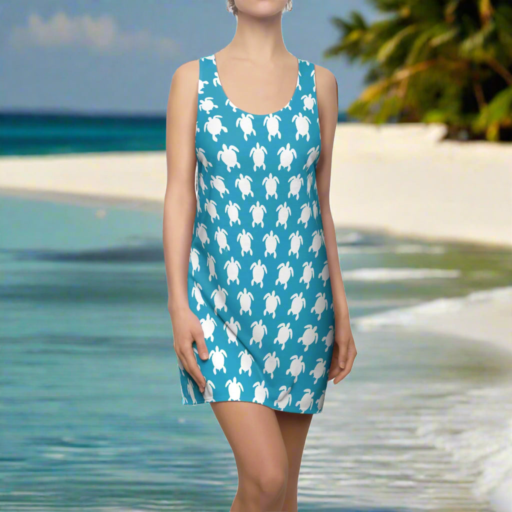 Sea Turtle Pattern on a turquoise Tank Top Beach Cover Dress worn by a swimwear model standing on the beach