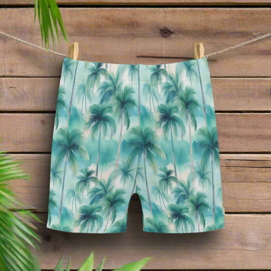 Swim shorts with palm tree pattern hanging on a line outside a classic old beach cottage 