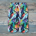 Colorful tropical-themed shorts with a white drawstring on a white background