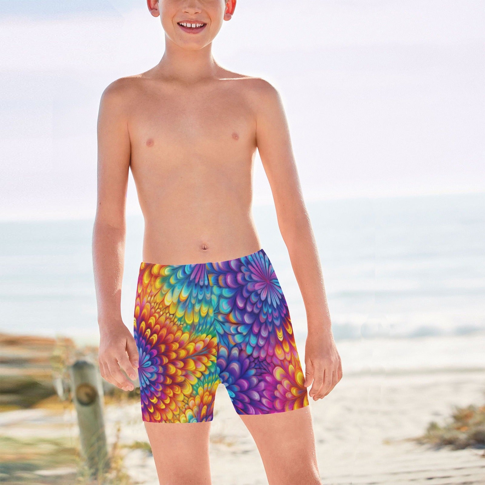 Teenage boy wearing colorful tie-dye swim shorts on a California beach
