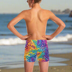 dude wearing colorful tie-dye swim shorts on a California beach