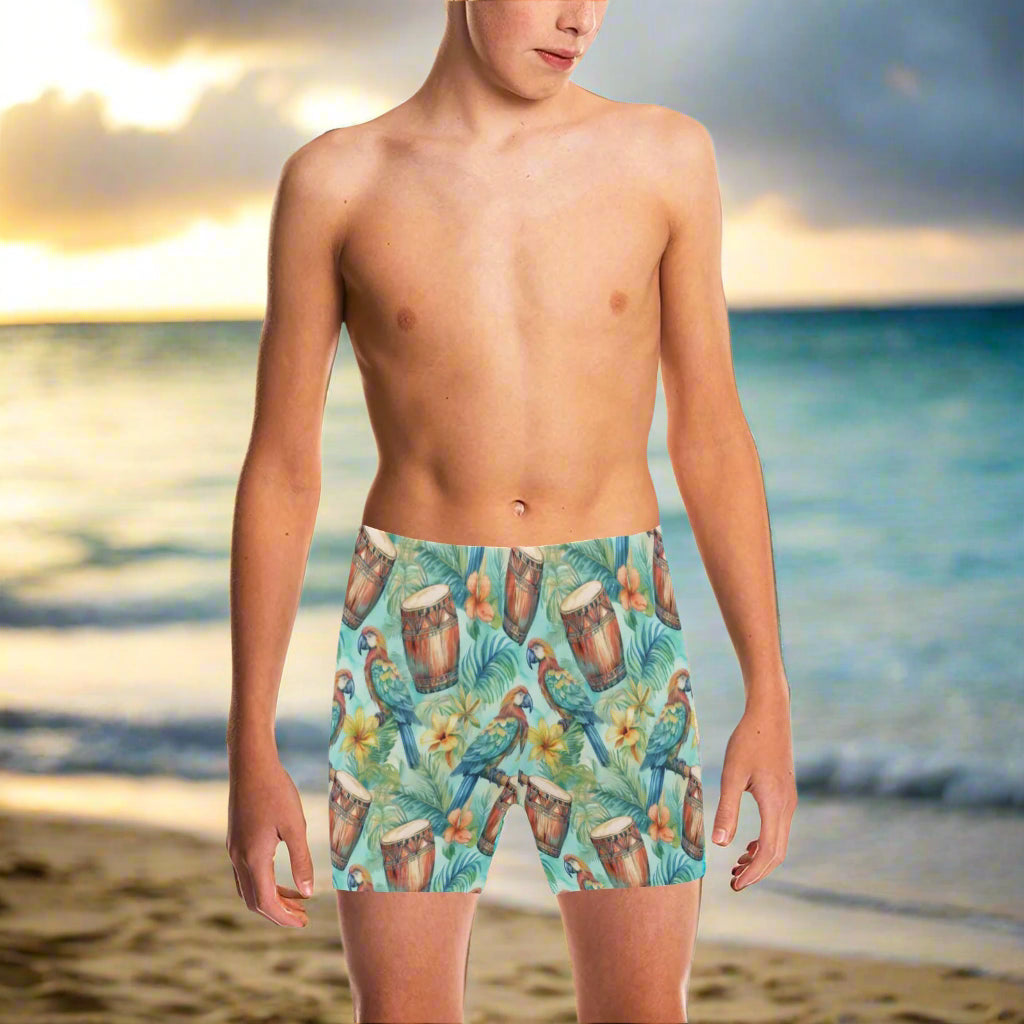 dude wearing colorful Hawaiian Style swim shorts with a tropical pattern hanging loose at the beach in Waikiki