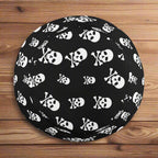 Black bucket hat with white skull and crossbones pattern on a nautical wood background