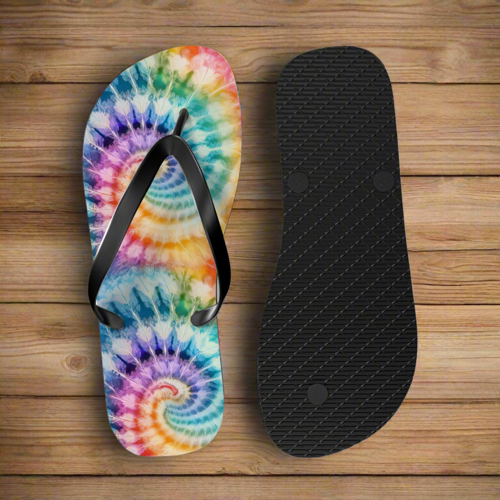 Tie-dye flip-flop sandals with a black insole on a rustic nautical wood background