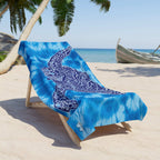 Tie Dye Beach Towel with Zen Sea Turtle Design draped over a lounge chair under a palm tree at the beach