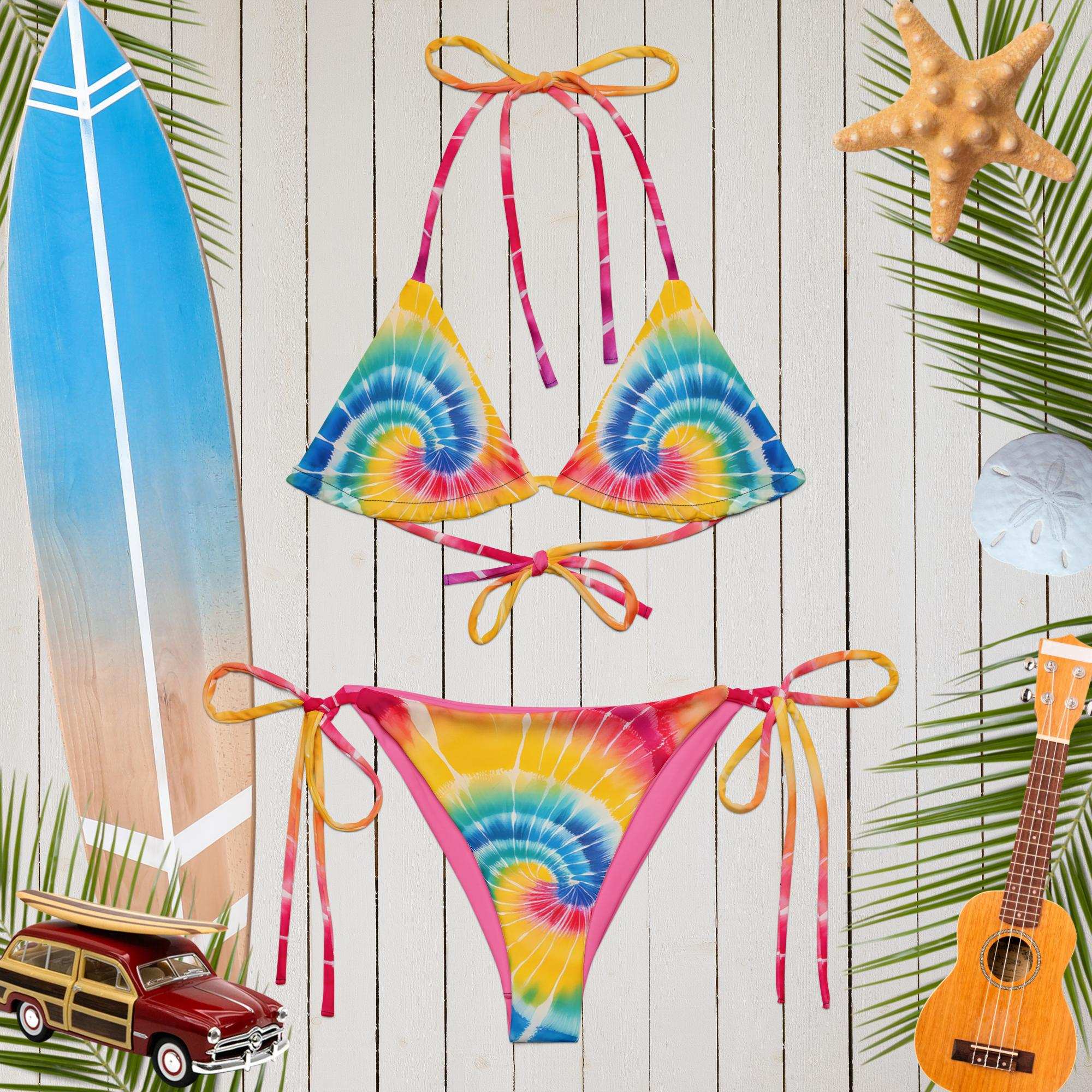 tie-dye string bikini floating over a rustic wood boat deck with surf icon around