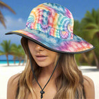 Colorful tie-dye bucket hat worn by a model on a beach background