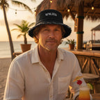 Dude wearing a WWJBD bucket hat at a beachside tiki bar