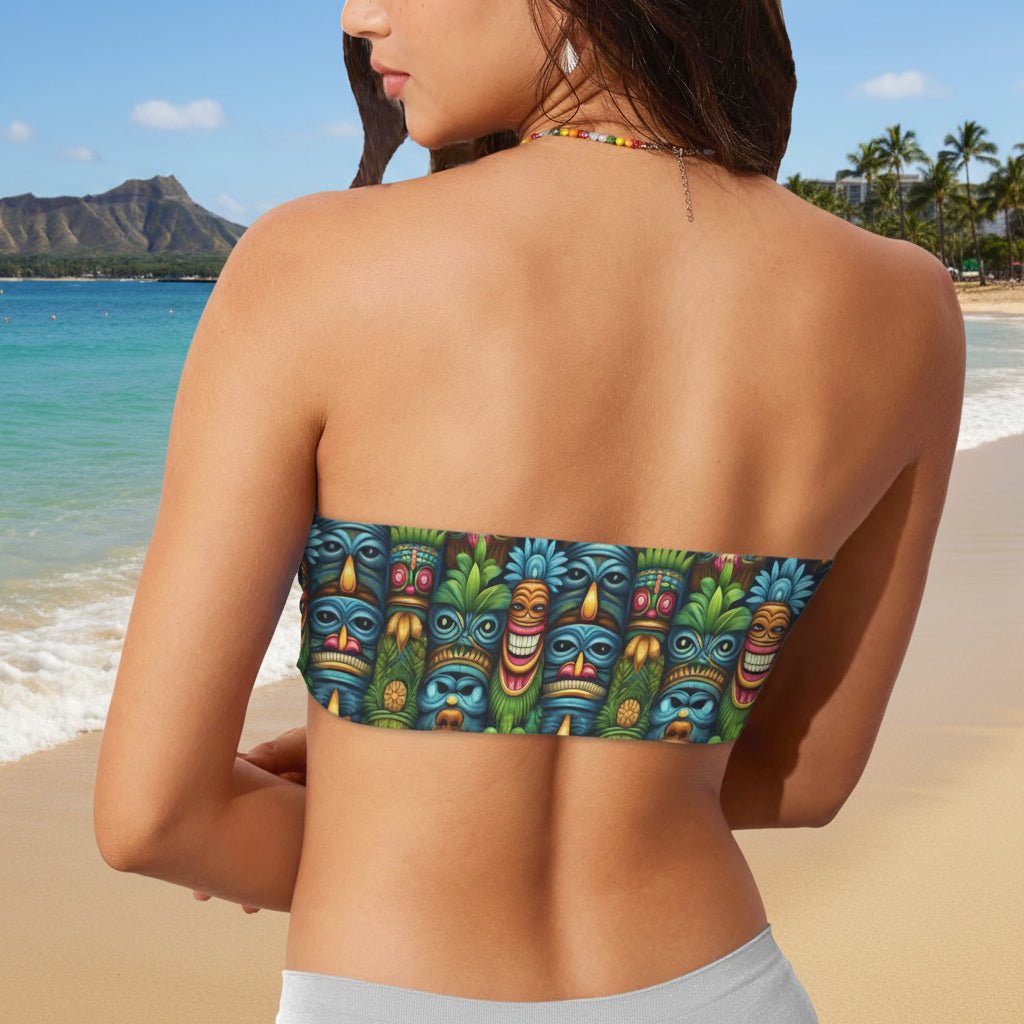 Woman wearing a strapless bikini top with colorful tiki mask pattern on Waikiki beach
