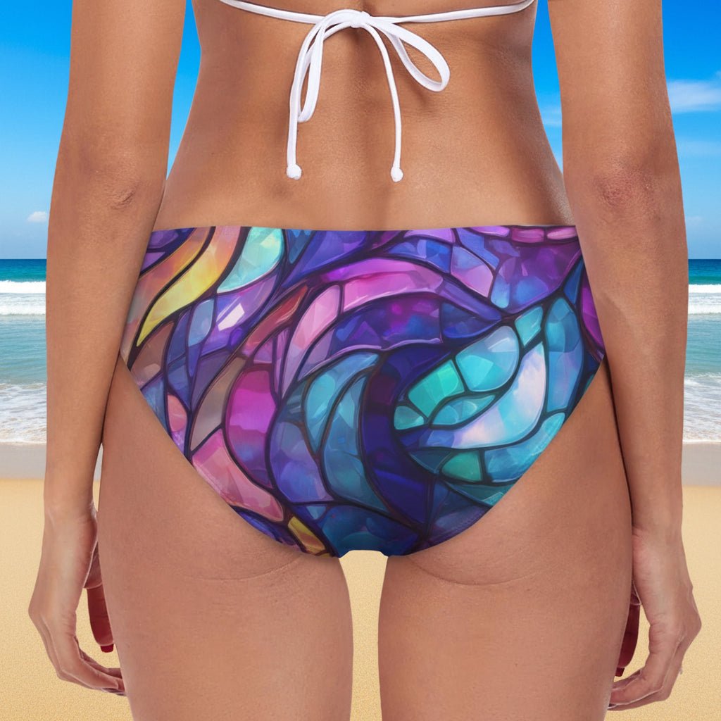 Colorful stained glass-patterned bikini bottom on a white background