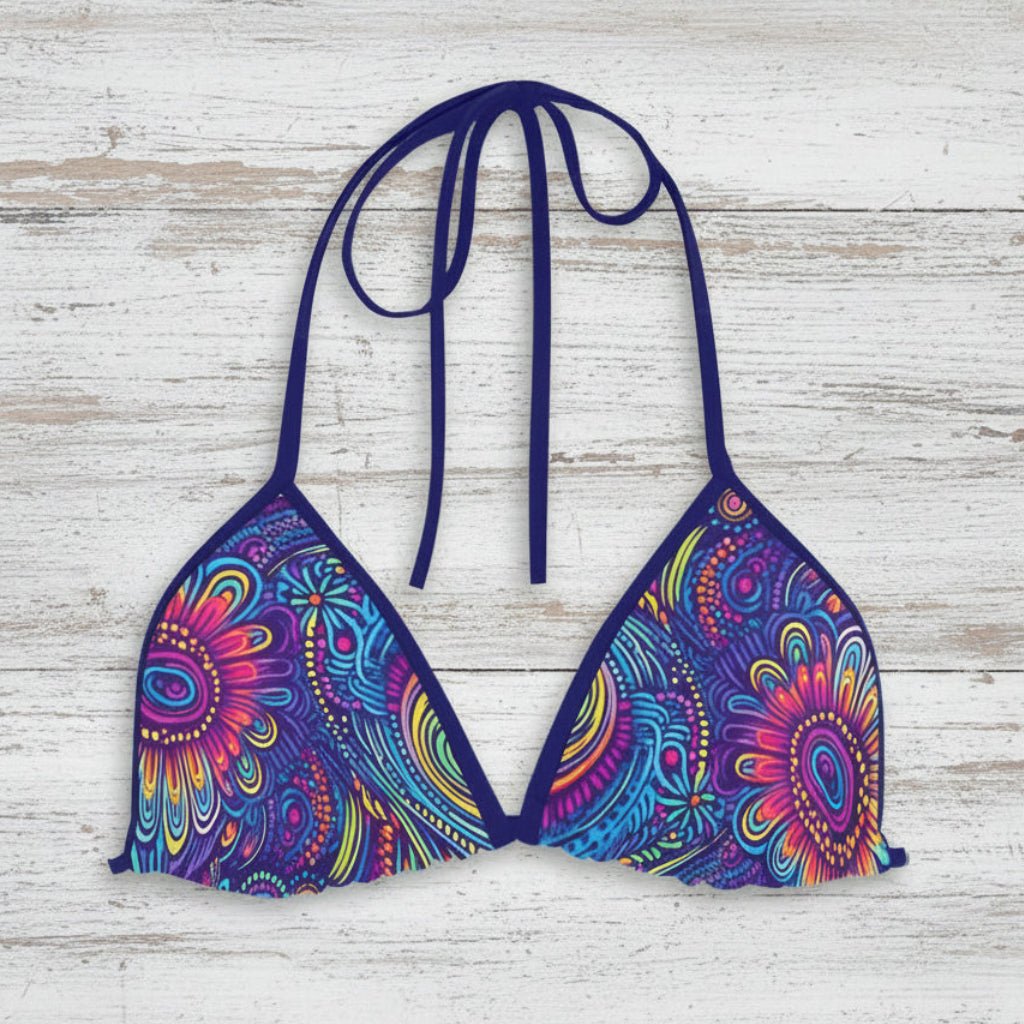 Colorful bikini top with floral pattern on a nautical wood background