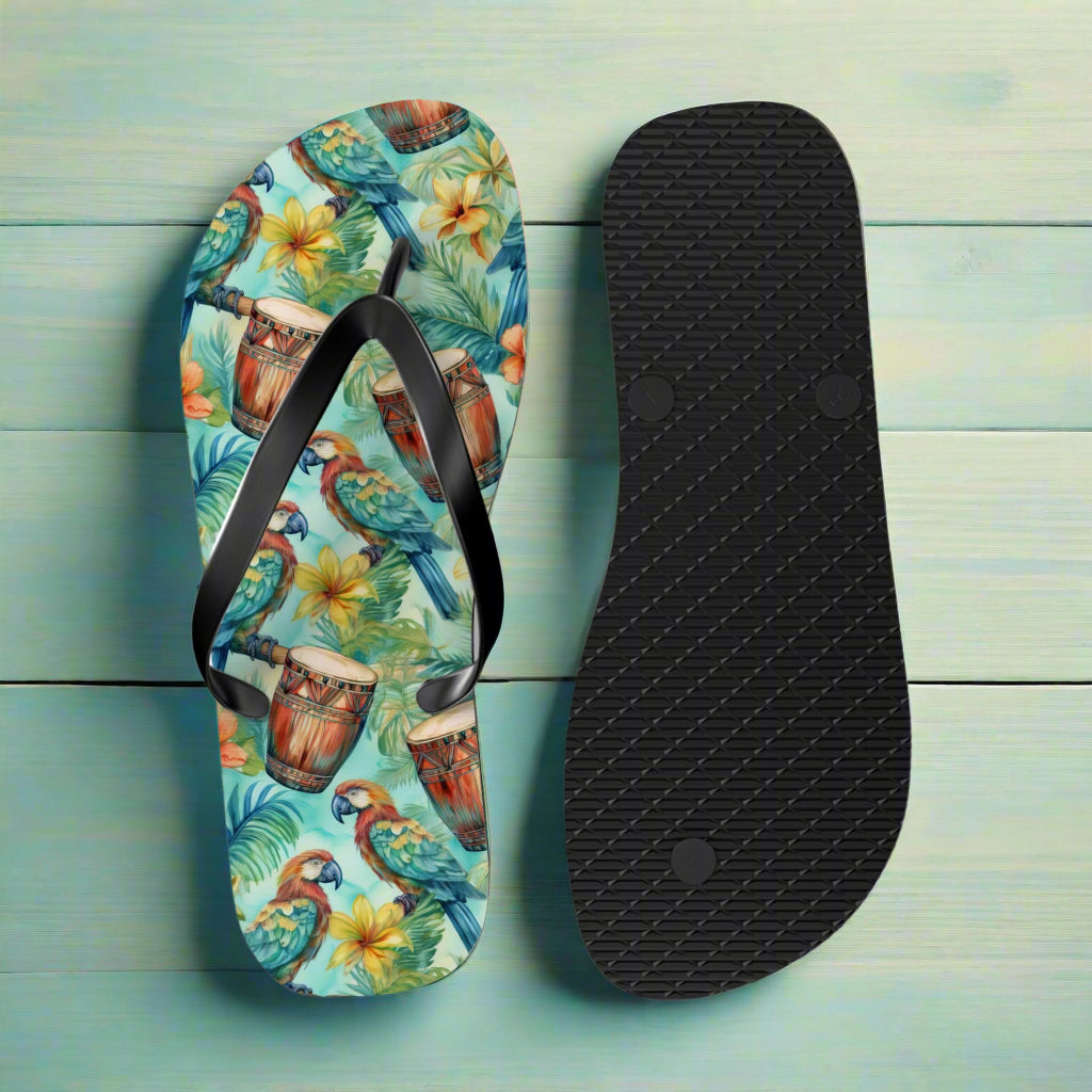 Flip-flop with tropical design featuring parrots, drums, and flowers on a nautical wood background.