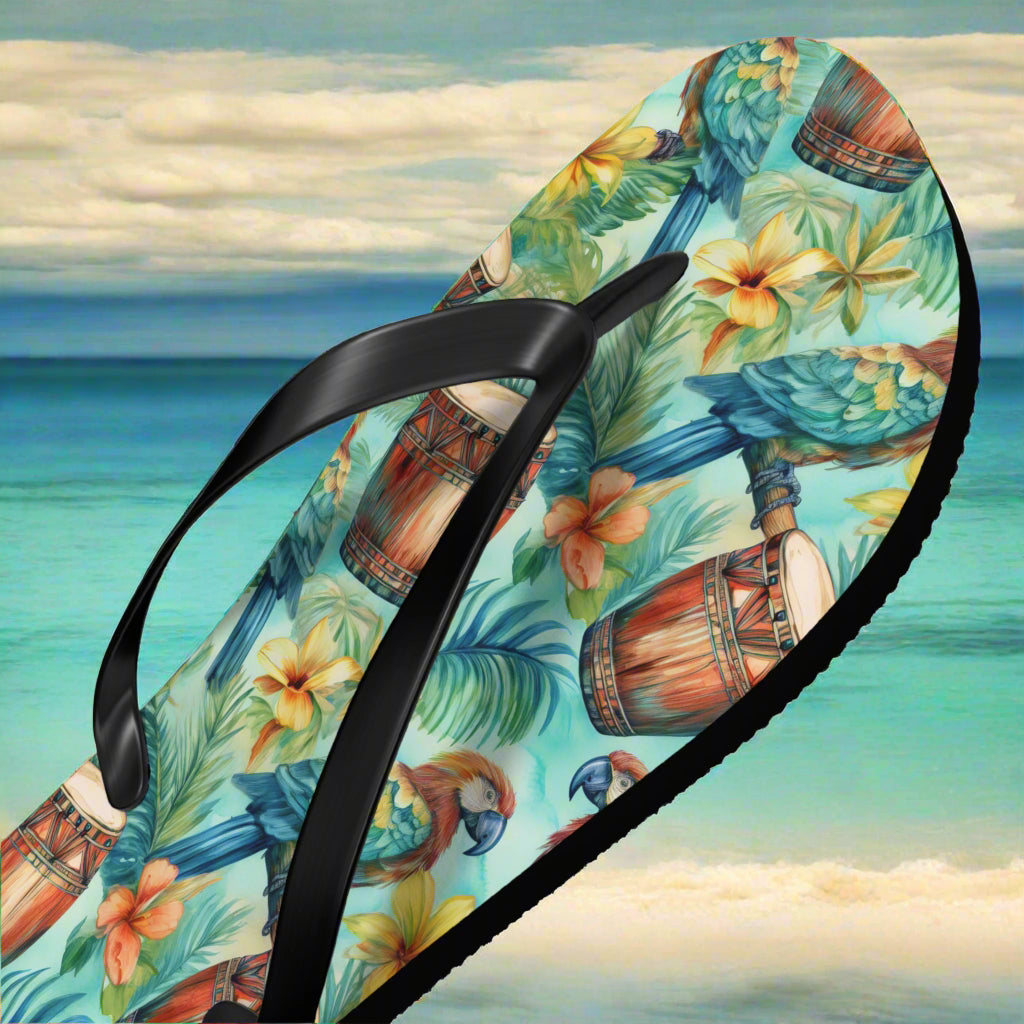 Flip-flop with tropical pattern on a beach background