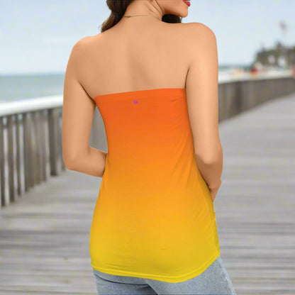 Woman wearing a strapless top with an orange to yellow gradient on a beachside boardwalk
