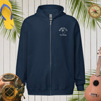 Navy blue hoodie with a logo on a wooden background with tropical elements.