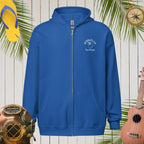 Blue hoodie with a logo on a wooden background with tropical elements