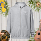 Gray hoodie with a logo on a wooden background with tropical elements