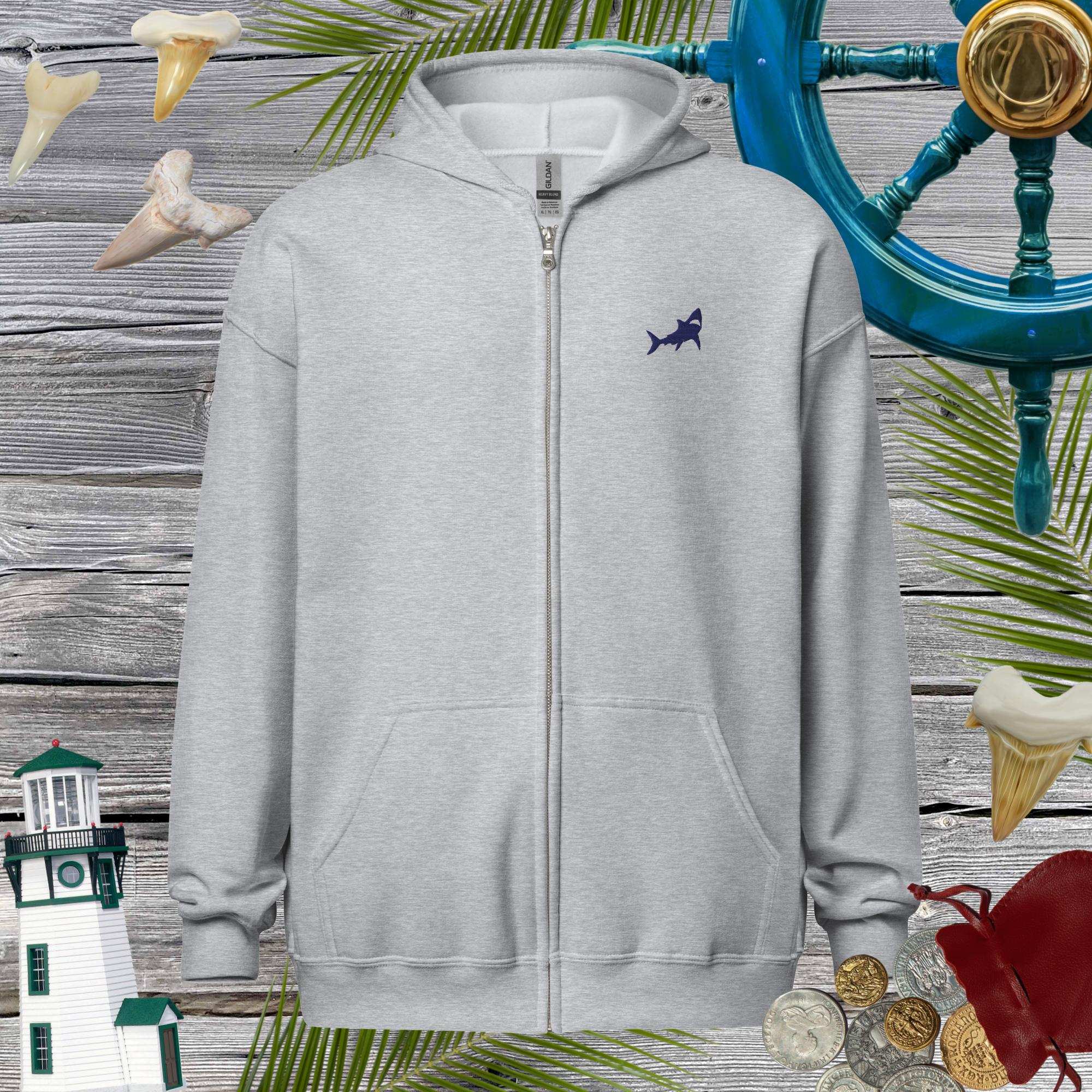 Gray hoodie with a shark logo on a decorative background with lighthouse, shark fins, and palm leaves.