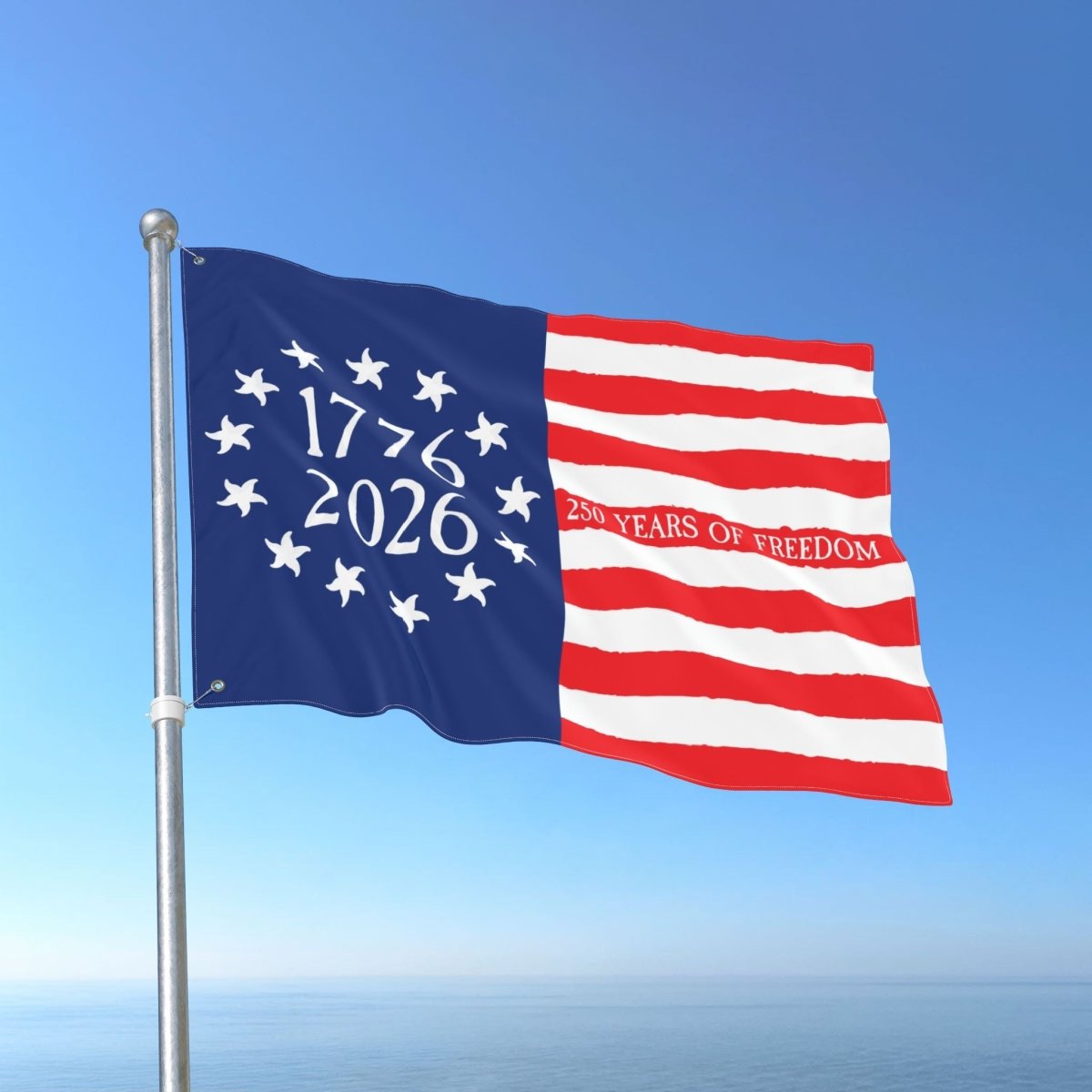 Flag with '1776 2026 250 Years of Freedom' text against a blue sky