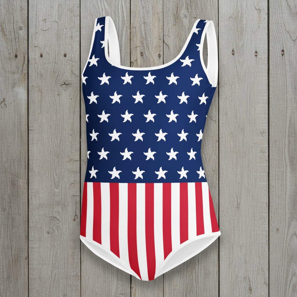 USA Flag One-piece swimsuit with American flag design on a rustic wood background