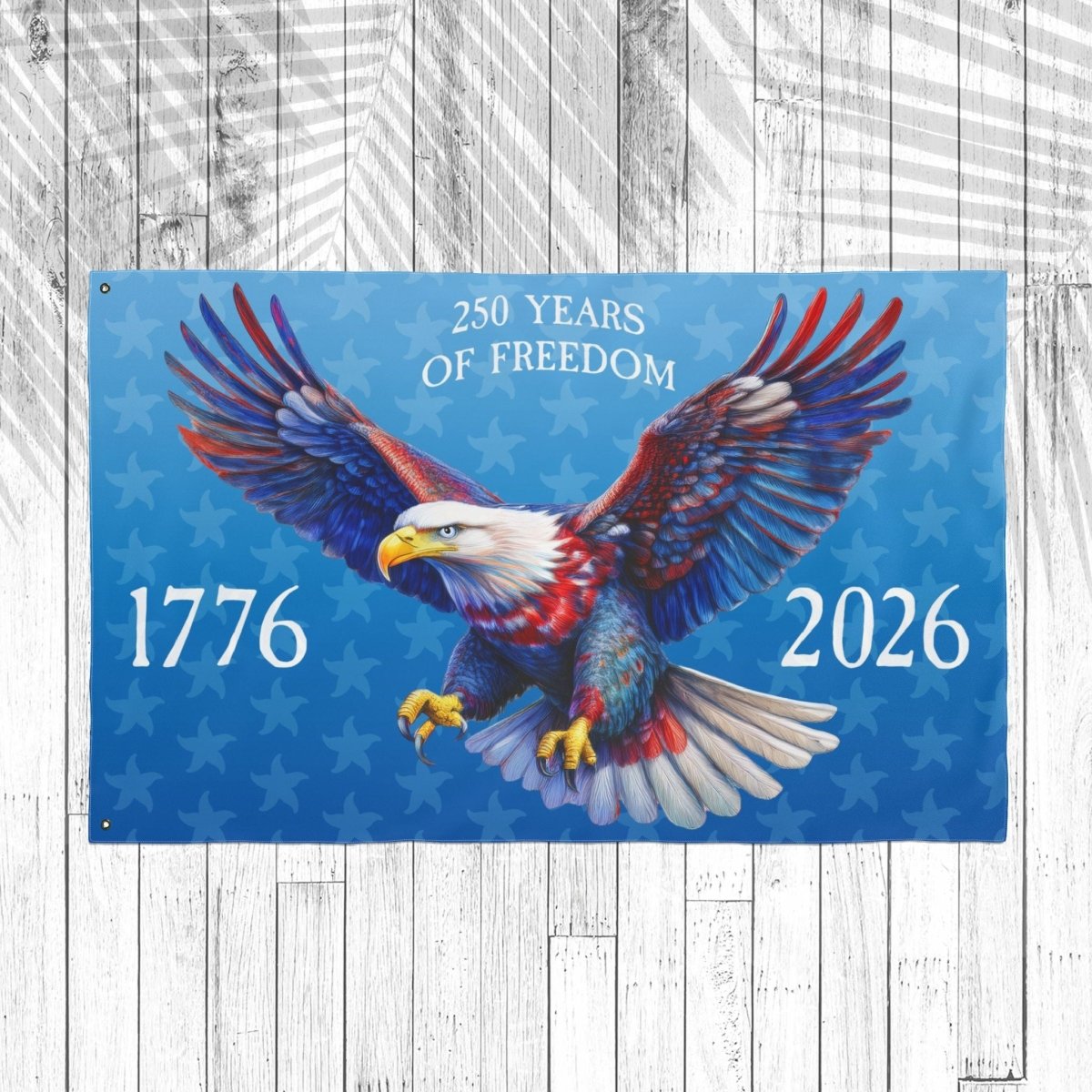 Flag with an eagle design celebrating 250 years of freedom, featuring the years 1776 and 2026 on a wooden background.