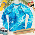 Surfer Kids Rag Dolled Rashie in vibrant blue, ideal for beach play with UV protection and fitted design.