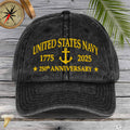 Black cap with 'United States Navy 1775-2023 250th Anniversary' text on a wooden surface.