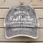 Gray cap with white text 'REBUILD THE Rod & Reel Pier Anna Maria Island' on a wood background