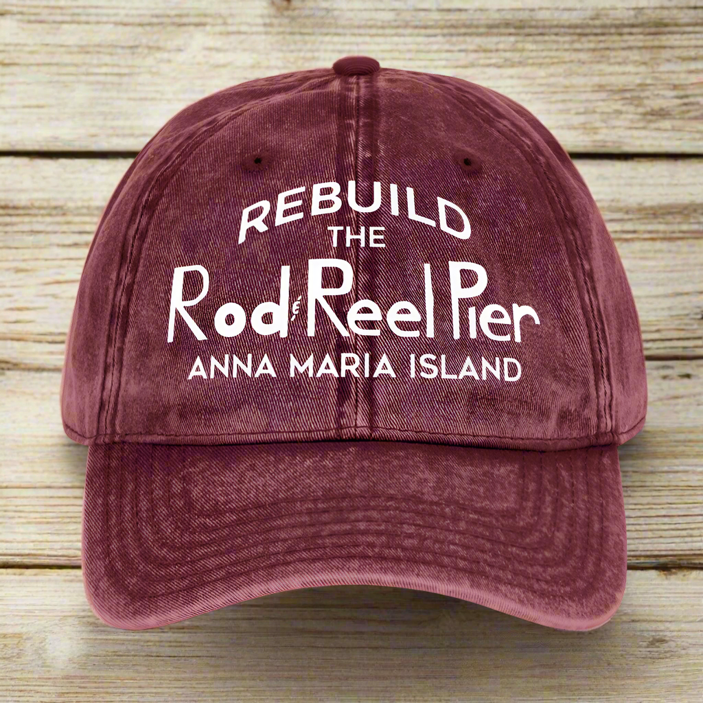 Maroon cap with white text on a nautical wood background