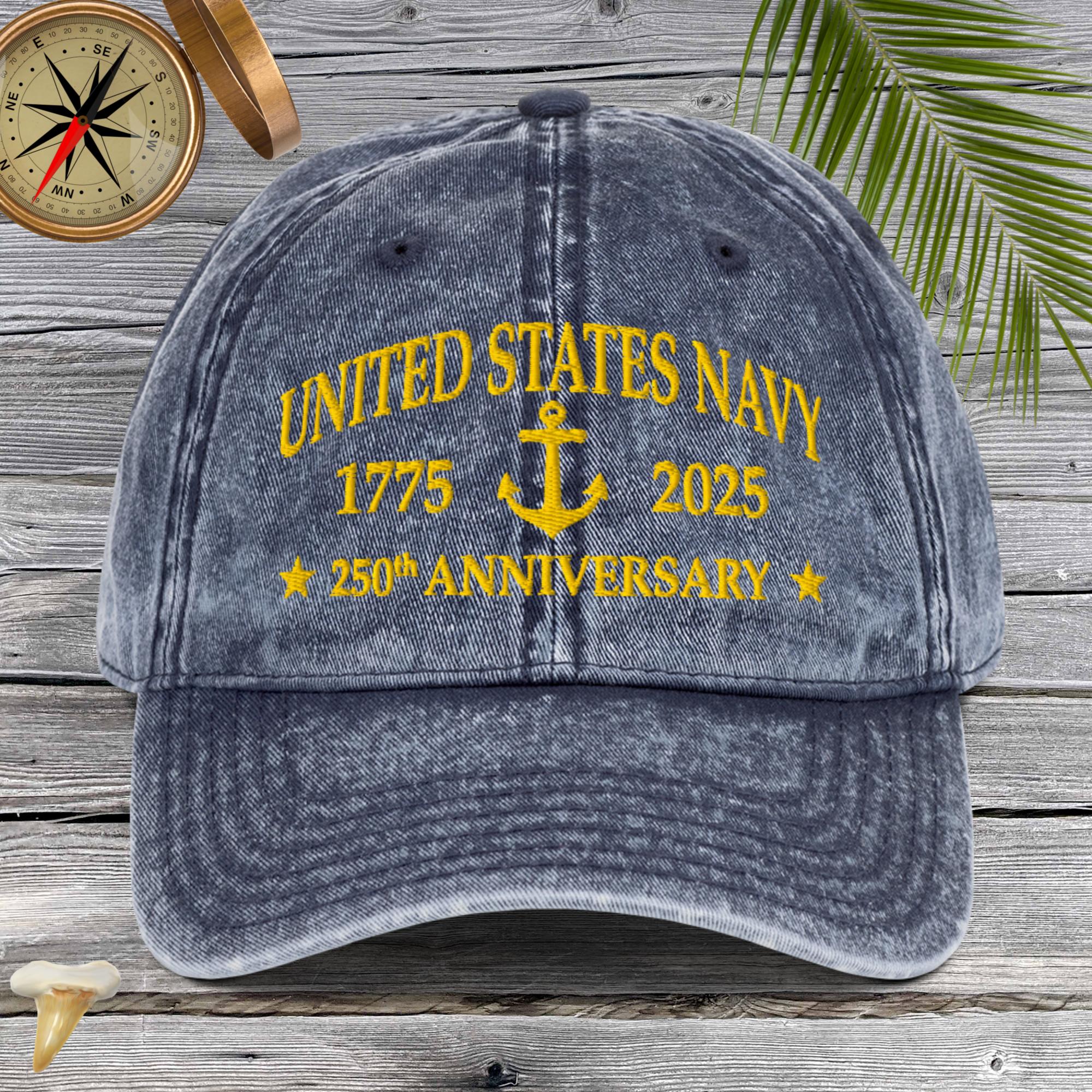 Gray cap with 'United States Navy 1775-2025 250th Anniversary' text on a wooden background